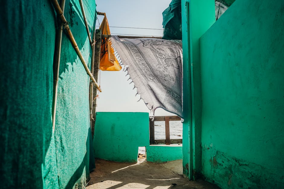 Colorful outdoor scene with hanging cloth in a seaside alley in Goa, India.